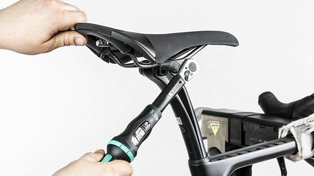 CyclErie technician performing lifetime free bike adjustment on customer eBike in Erie CO shop — quick brake and gear fixes included forever