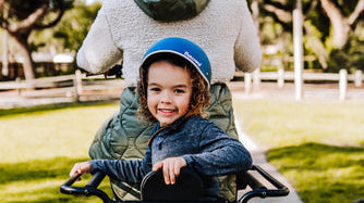 Image of a small child riding on the back of an electric cargo bicycle