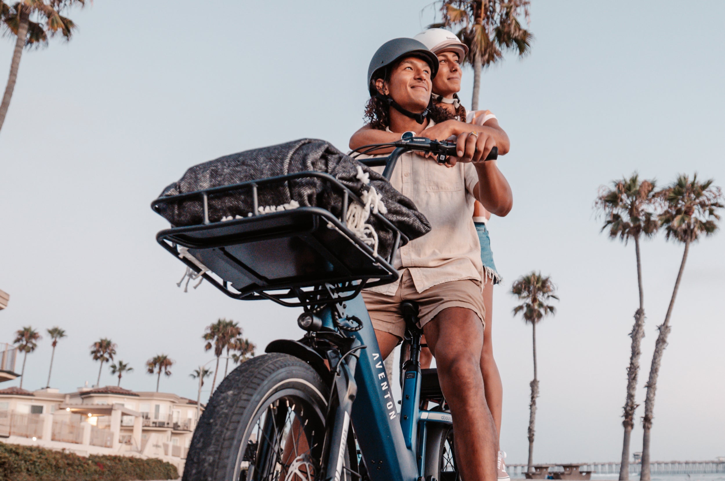 Aventon Abound SR cobalt with a rider carrying a passenger and front rack set installed now available at CyclErie bike shop in Erie CO.
