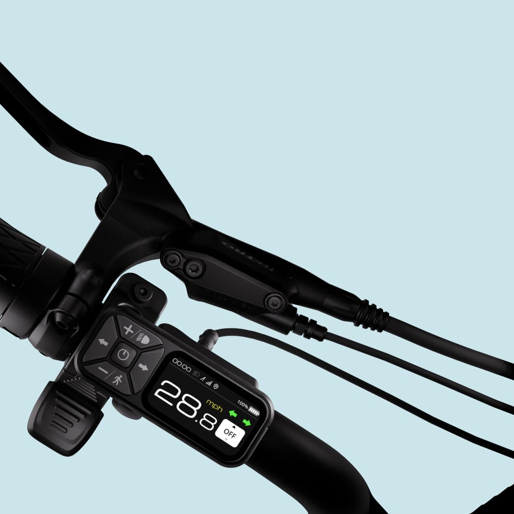 Bicycle handlebar with digital display on a light blue background on an Aventon Pace 4 cruiser casual electric available at CyclErie in Erie, CO.