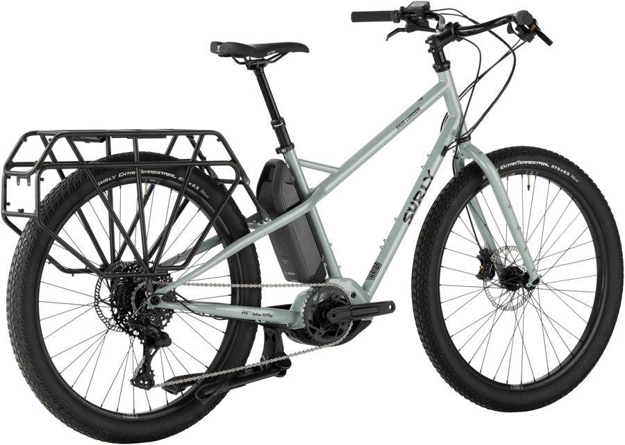 Compact Surly Skid Loader electric cargo bike with steel frame, parked in urban alley.