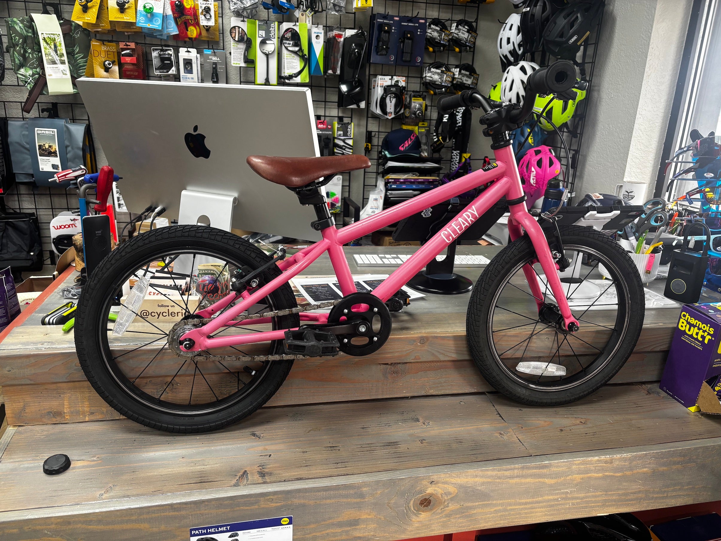 Pre-loved Punk Rock Pink Cleary Hedgehog 16-inch kids bike from CyclErie, faded vibrant color, ideal for Erie Community Park pump track and Valmont Bike Park dirt trails.