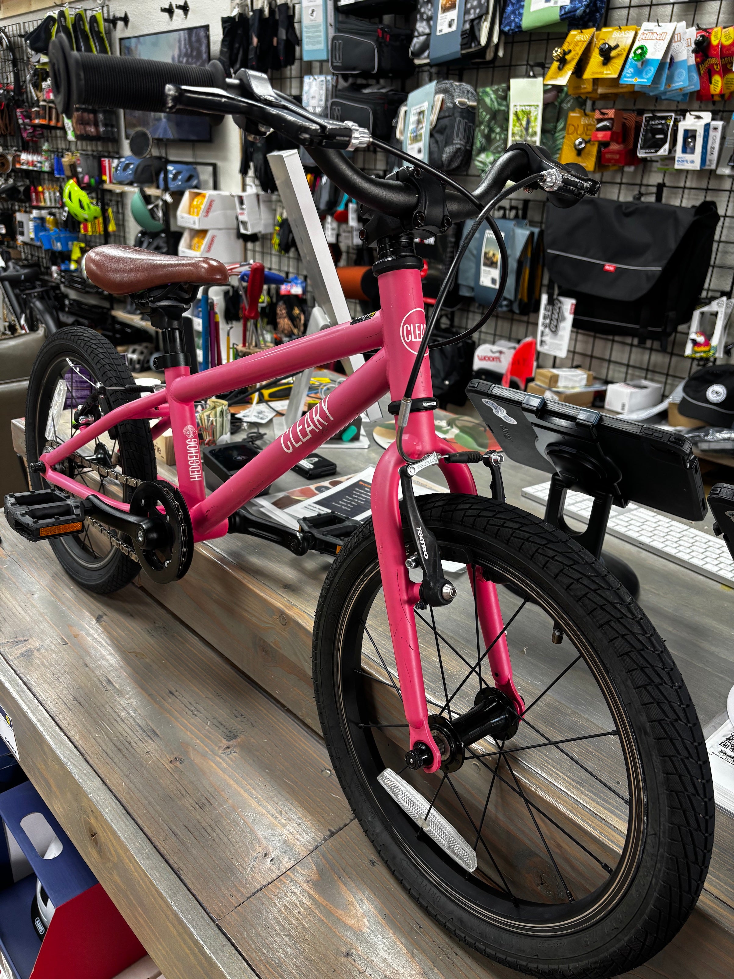 Pre-loved Punk Rock Pink Cleary Hedgehog 16-inch kids bike from CyclErie, faded vibrant color, ideal for Erie Community Park pump track and Valmont Bike Park dirt trails.