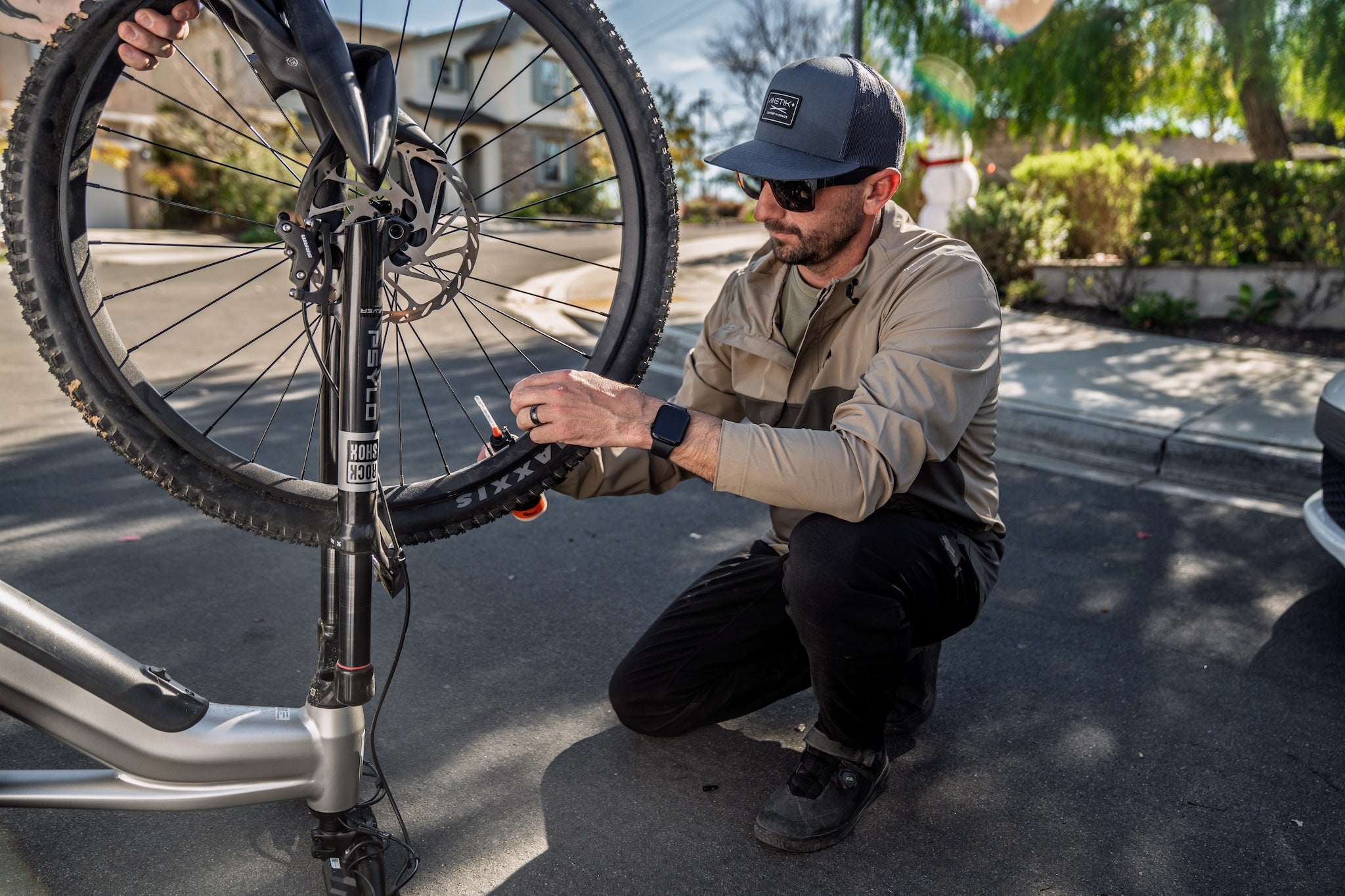 Man working on Aventon Ramblas ADV Upside Down Tubeless Refresh Orange Seal