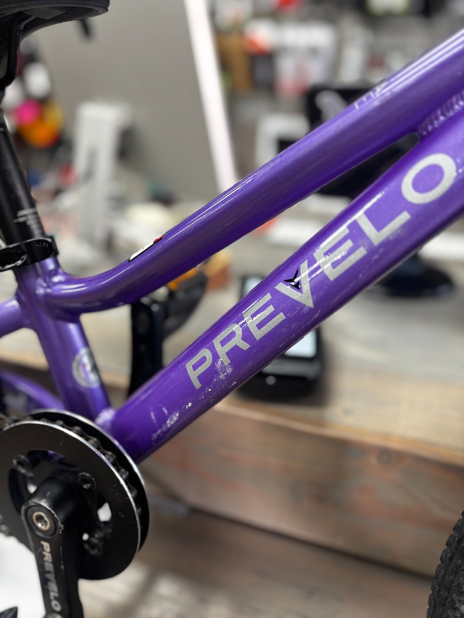 Front-angle view of a used Prevelo Alpha One 14-inch bike in Power Purple, showcasing its compact frame and tires, perfect for trails or pump tracks.