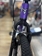 Close-up of the Power Purple Prevelo Alpha One 14-inch kids' bike, highlighting its sturdy handlebars and small pedals, ideal for young riders.