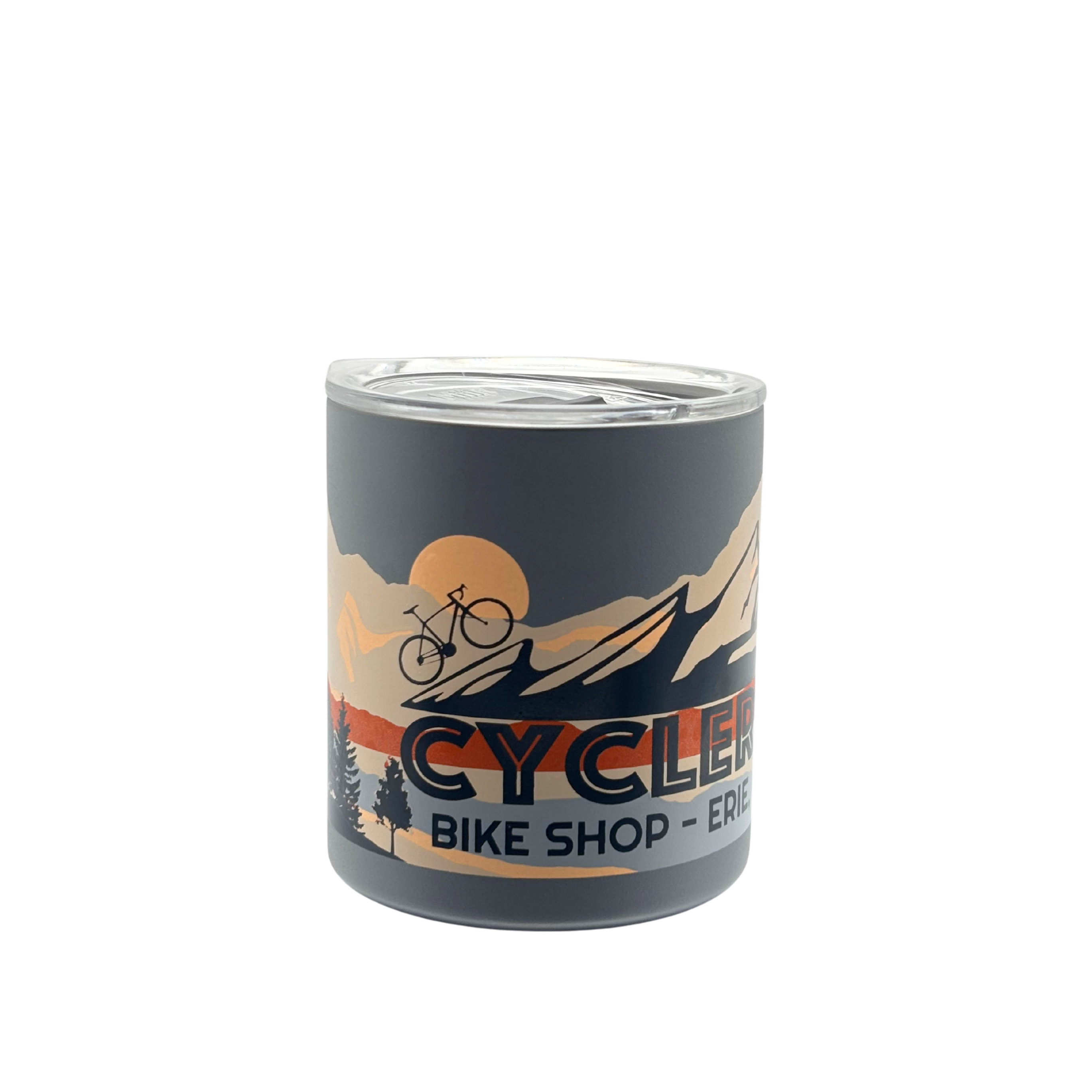 Matte grey CyclErie Miir camp cup filled with steaming coffee, held by a gloved hand next to an e-bike on a snowy Erie, Colorado singletrack—logo and Erie Colorado text clearly visible.