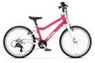 The Woom Go 4 is a pink and white lightweight kids bike for ages 6+ at CyclErie, featuring an ultralight aluminum frame, black seat and handlebars, two large wheels with white rims and red accents, and woom in white on the frame.