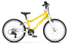 A yellow and white Woom Go 4 kids’ bike for ages 6+ at CyclErie, featuring an ultralight aluminum frame, black handlebars, saddle, tires, 20-inch wheels, front and rear brakes, and the Woom brand name on the frame.
