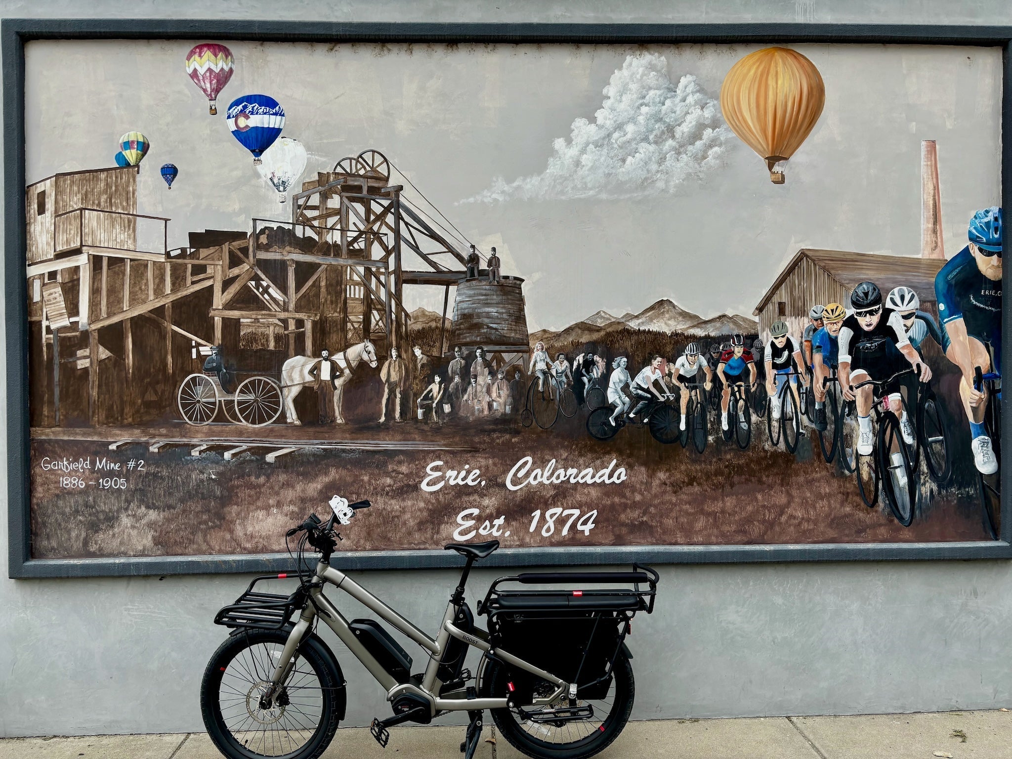 Benno Boost in Front of a Mural in Historic Old Town Erie CO