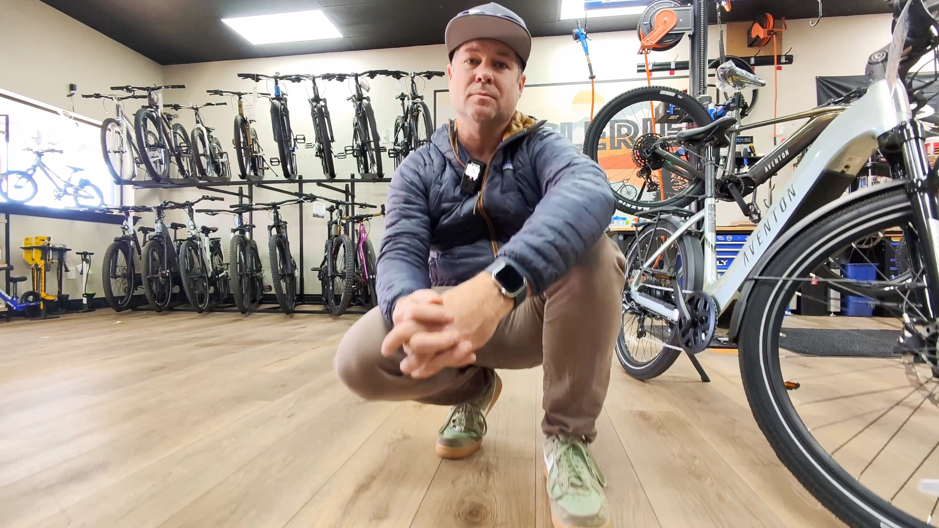 DJ Kneeling at CyclErie with the Aventon Level.3 Commuter in Glacier Mint