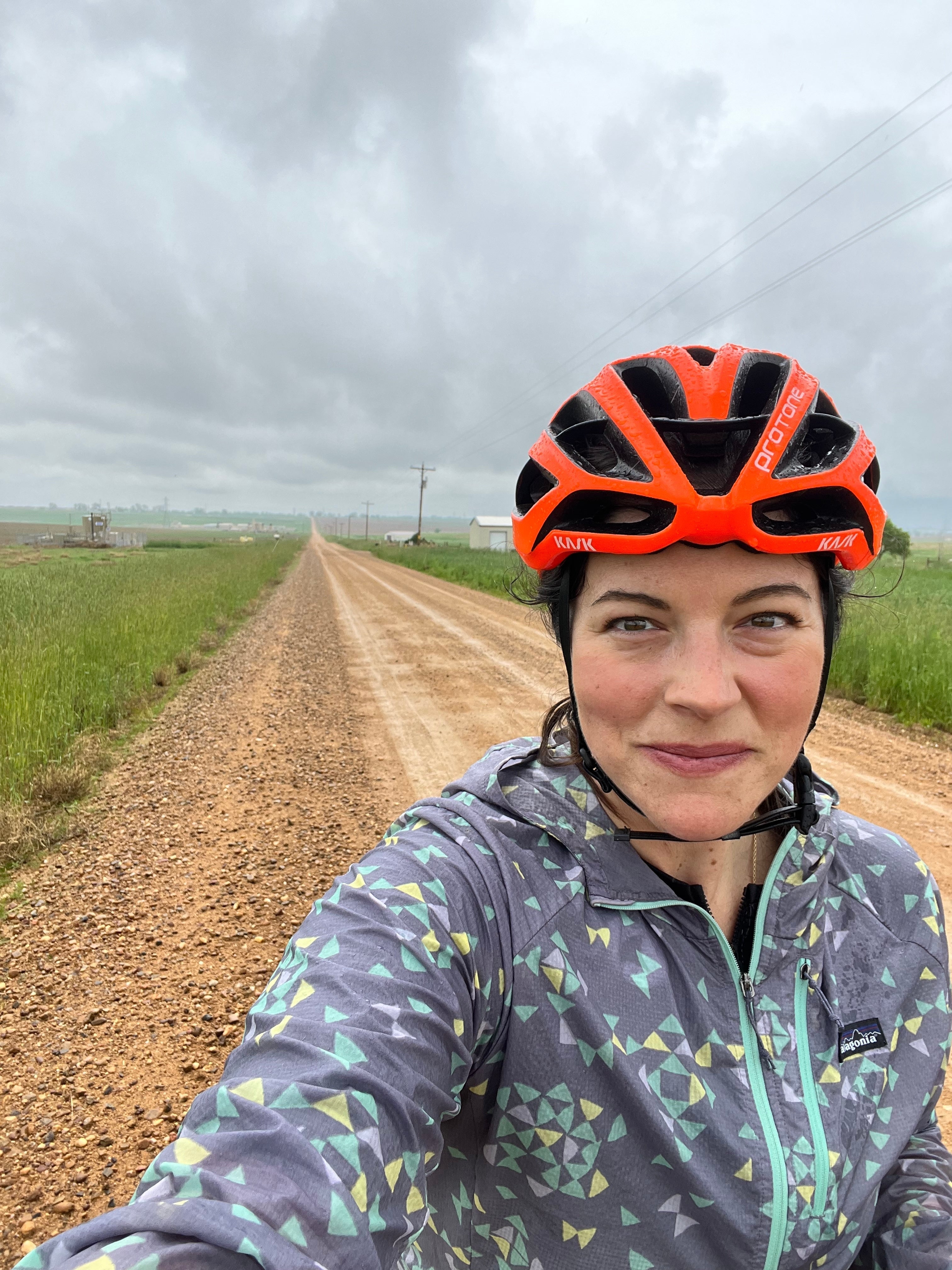 eBike rider in an orange helmet on a gravel trail near Erie, Colorado