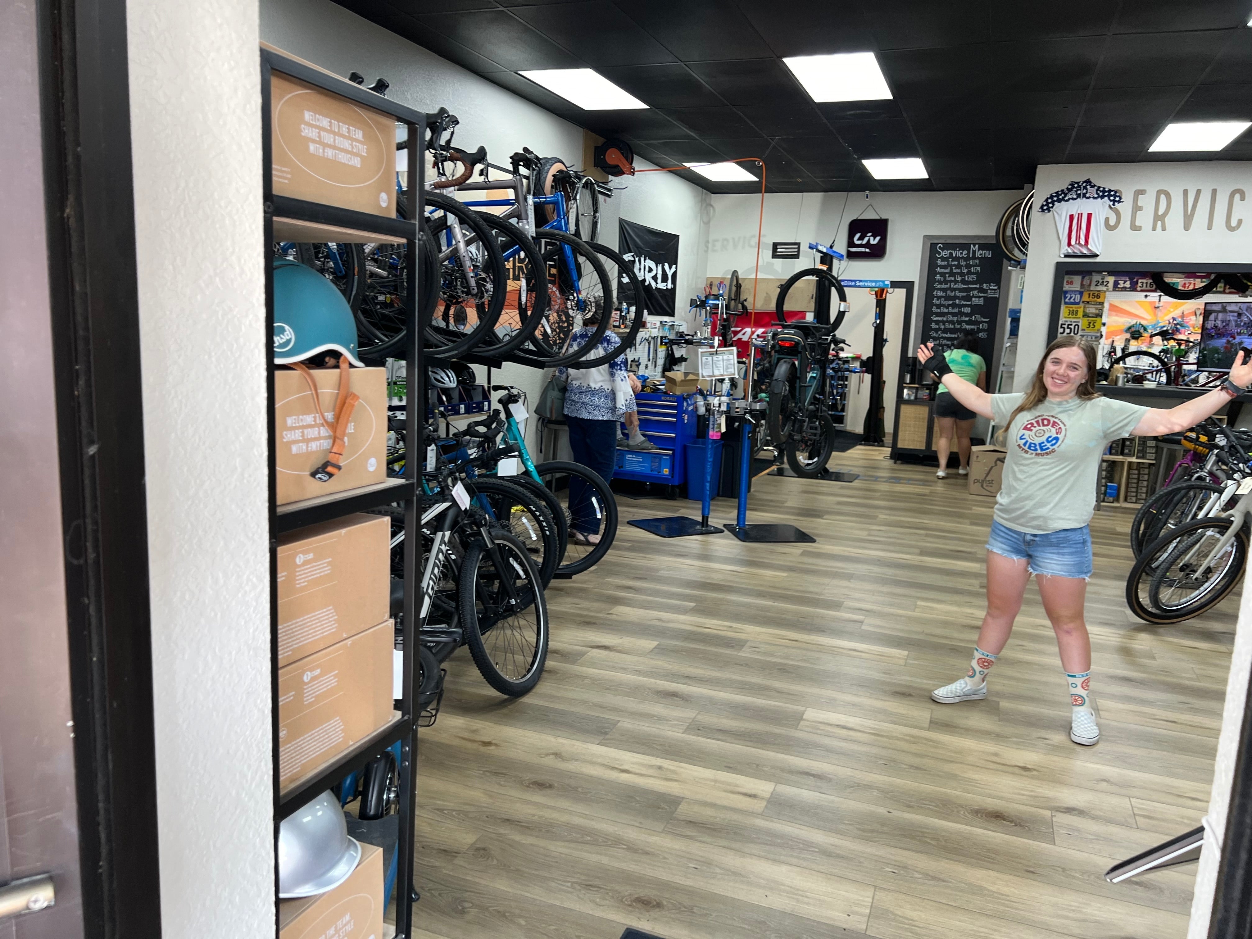 CyclErie bike shop team in Erie, Colorado, standing in front of a variety of mountain bikes for sale, e-bikes, and cycling gear, showcasing their expertise in the Front Range.