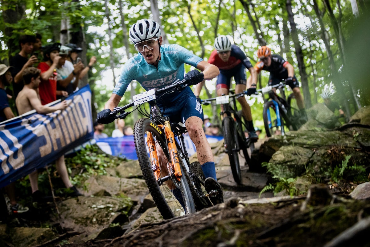 Person riding a downhill mountain bike on a technical world cup DH trail