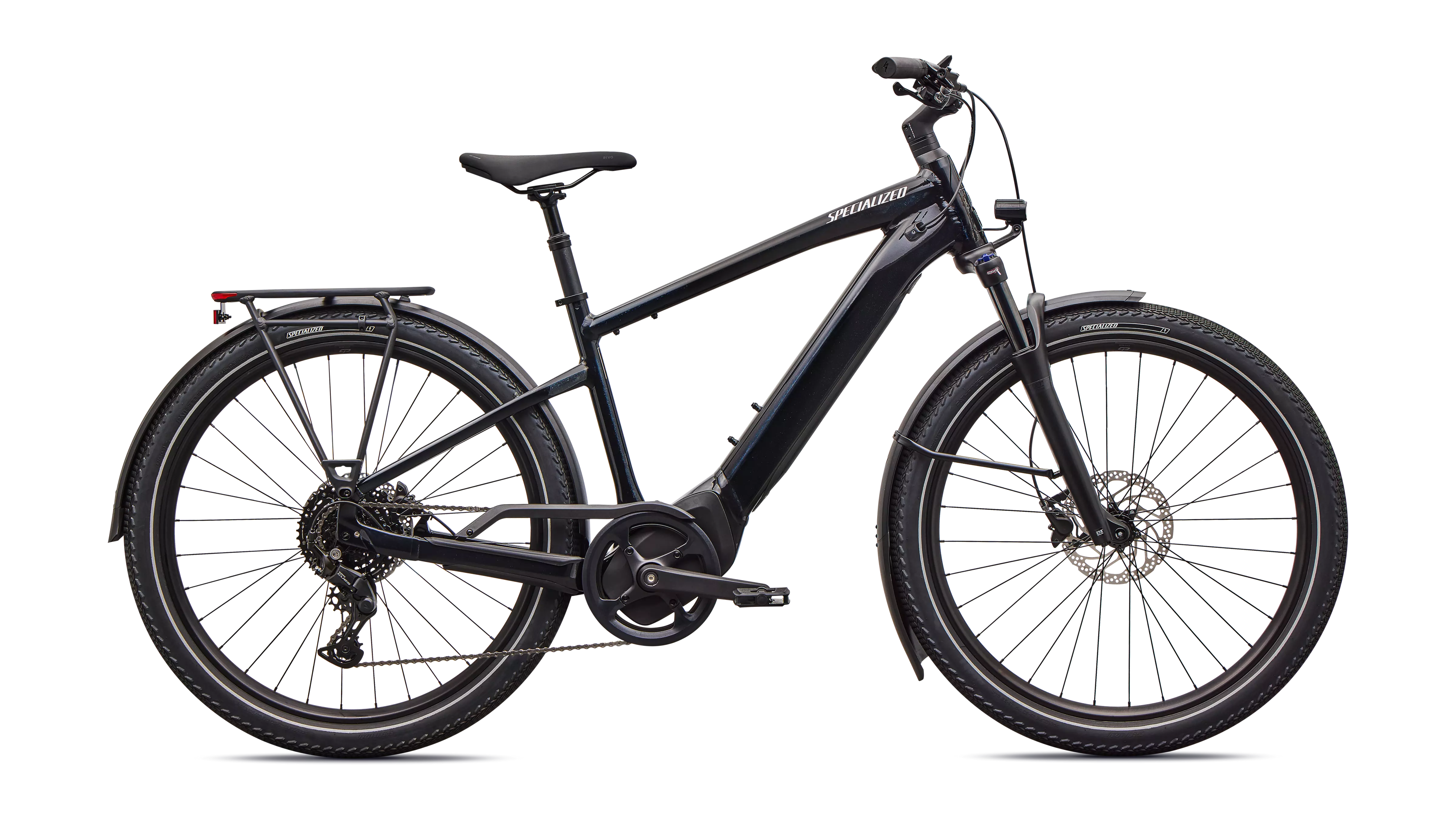 Night ride action shot of the Turbo Vado 4.0 with full LED lighting system illuminating a lakeside trail, hydraulic disc brakes ready, suspended seatpost in motion.