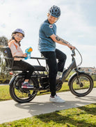 Dad and child riding an Aventon Abound LR on a sunny day.