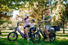 Parents, a mom and dad, with their children commuting to the park on the Aventon Abound SR and Abound LR ebike now available at Erie, CO.