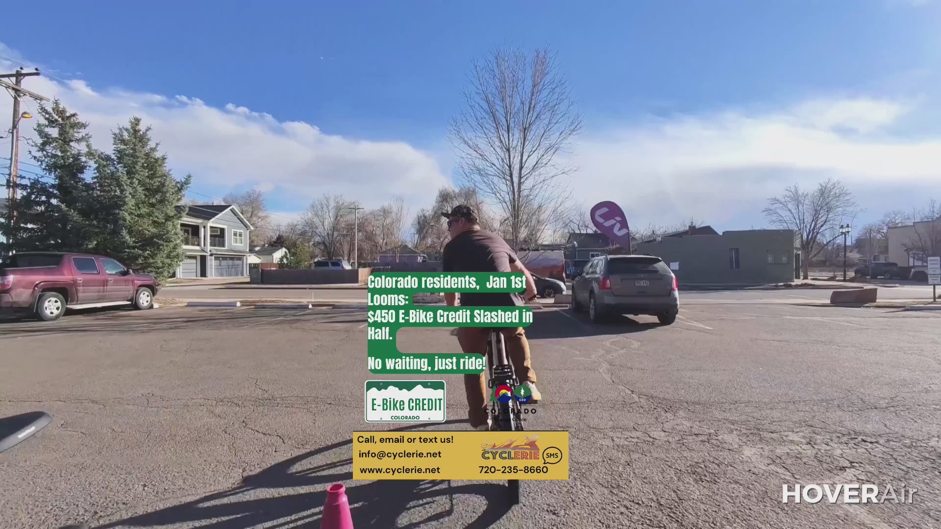 Rider enjoying a smooth, powerful cruise on the Aventon Level.3 commuter eBike along Erie’s scenic Coal Creek Trail with historic brick buildings and mountain backdrop. Schedule your free CyclErie test ride now and get $50 off same-day purchase
