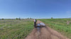 Man riding Aventon Aventure 3 e-bike on a scenic trail in Erie, Colorado, under bright sunny skies, showcasing adventure, power, and style.
