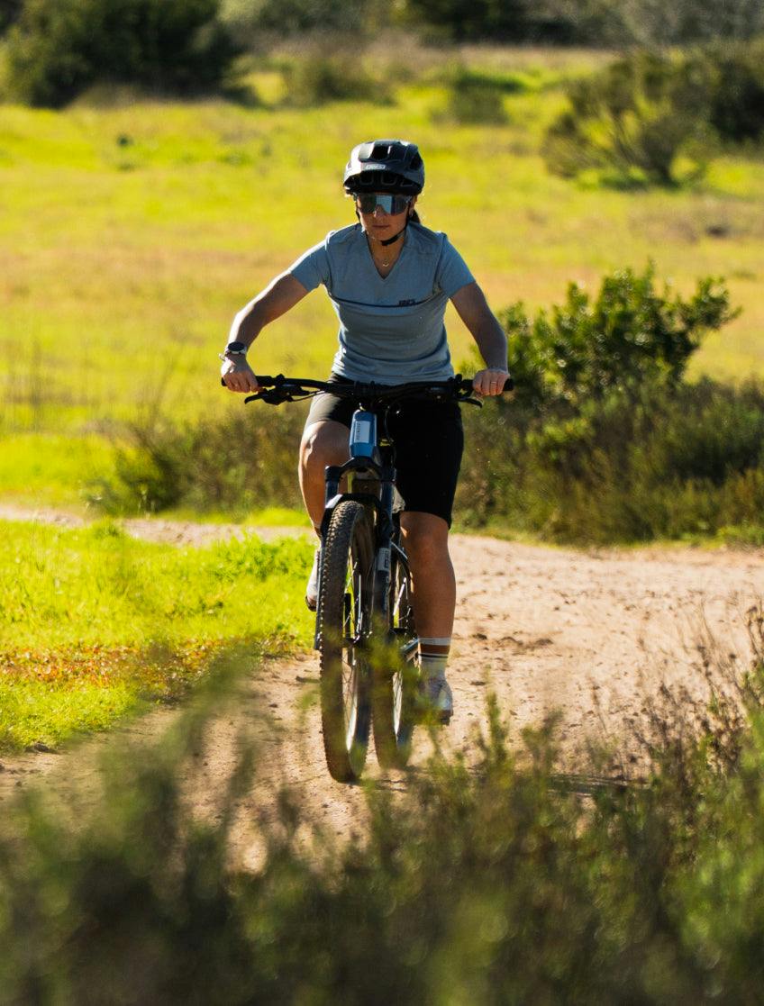 Riding the Aventon Ramblas ADV eMTB on singletrack, available at CyclErie in Erie, CO.