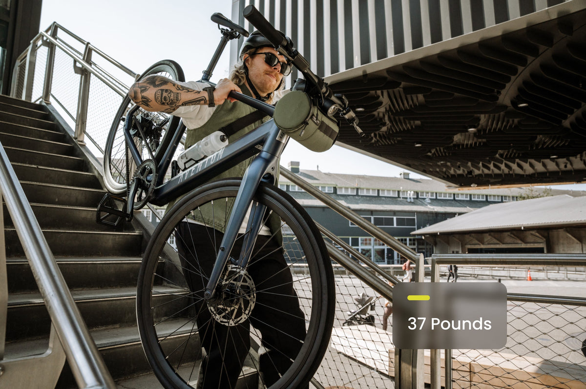 Carrying the 37 lb Aventon Soltera 3 ADV ebike up stairs, available at CyclErie in Erie, CO.