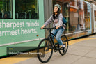 Rider on the Aventon Soltera 3 ADV belt drive ebike in the city, available at CyclErie in Erie, CO.